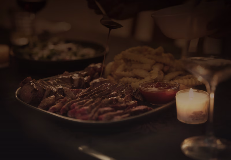 A candlelit meal being served